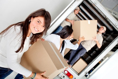 Professional movers transporting furniture during an Edgware relocation
