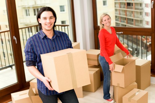 Small removals team loading furniture for transport in Edgware